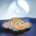 Colorful 3D printed Nemo lamp with LED light, illuminated from behind with a sleek and playful design, perfect for decor or children’s room lighting.