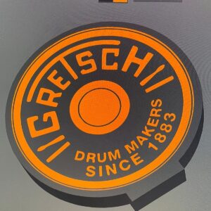 Puce de protection pour batterie de micro ou instrument de musique, conçue en impression 3D noir et orange avec texte "Reeschli" et "Drum Makers Since 1883".