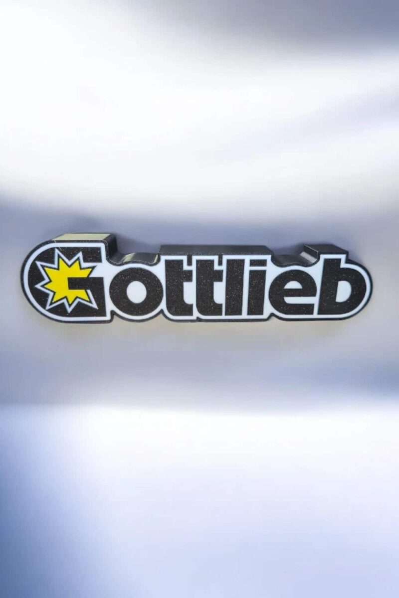 Logo personnalisé 3D lumineux avec texte "Gottlieb" et étoile jaillir en jaune, création LED 3D, conception unique, décor lumineux pour maison ou bureau, fabrication artisanale, design moderne et original.