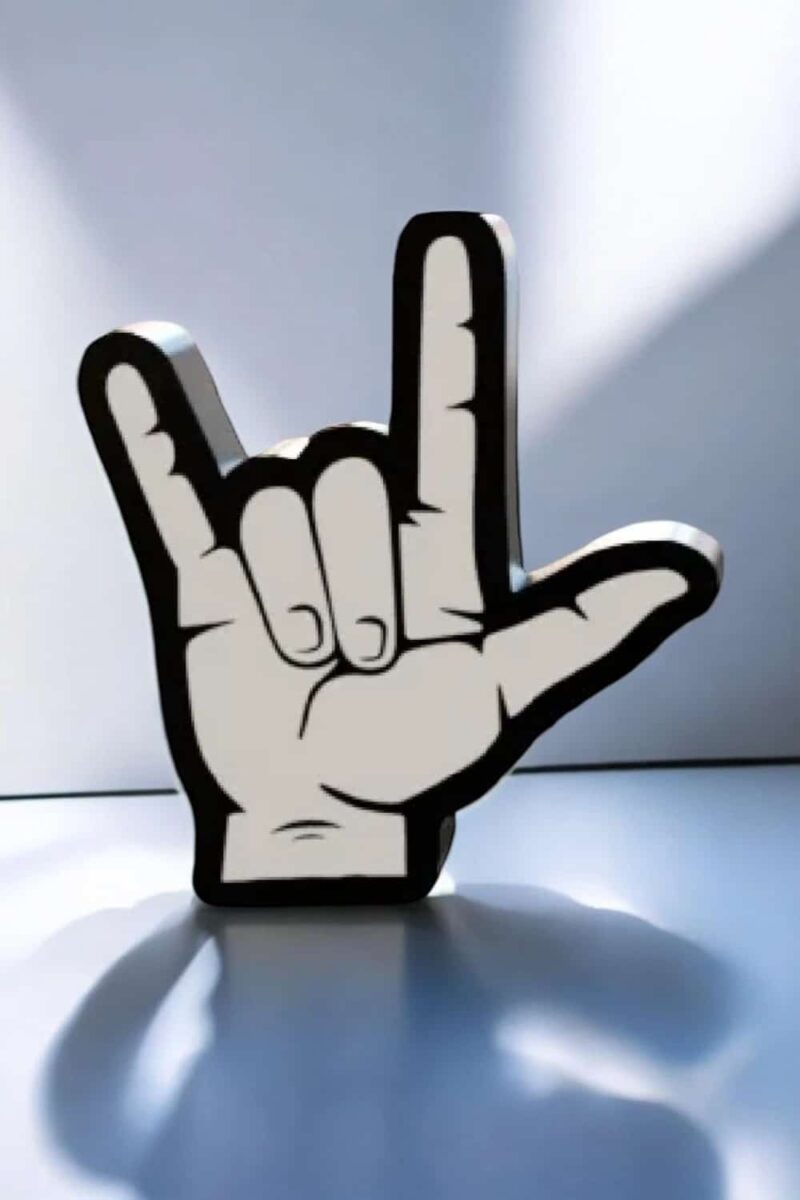 Lumière d'une lampe LED en forme de main faisant le signe des cornes avec contour noir et intérieur blanc, créant un objet lumineux original et design.