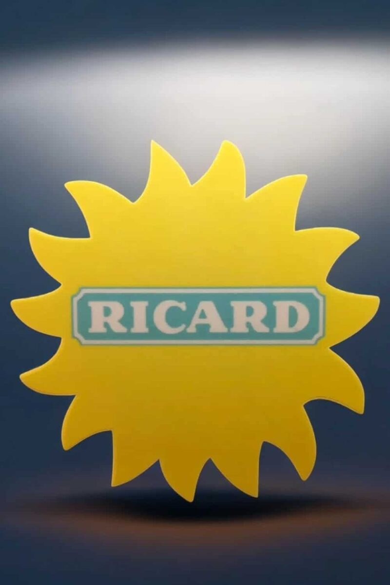 Rond jaune lumineux avec prénom "RICARD" en lettres bleues sur fond blanc, décoration moderne et lumineuse pour événements ou objets personnalisés.