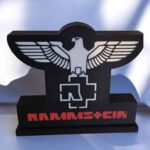 Lampe LED 3D Ramms+Ein avec logo en style industriel, éclairage lumineux et design moderne pour décoration intérieure et ambiance musicale, création originale en impression 3D.