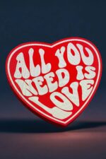 Lanterne LED en forme de cœur avec message lumineux « All You Need Is Love » pour décoration intérieure romantique ou cadeau personnalisé.