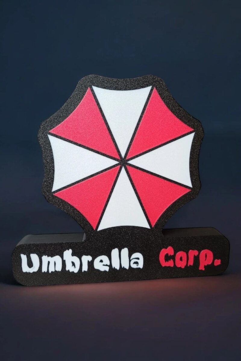 Lampe 3D LED personnalisée inspirée de Resident Evil Umbrella, design lumineux avec logo coloré, idéale pour décoration Geek, jeux vidéo et collection.
