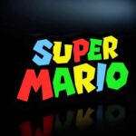 "LED lumineuses 3D avec le texte 'Super Mario' en couleurs vives sur fond noir, créant un effet lumineux attractif et coloré.".