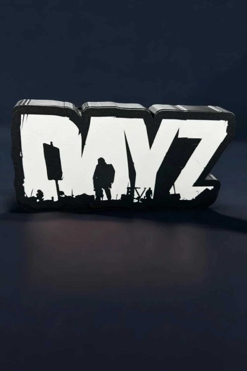 Un panneau lumineux en 3D avec le mot "DAYZ" et des silhouettes de personnes, réalisé avec la technologie d'impression 3D, illuminé pour un effet moderne et artistique.
